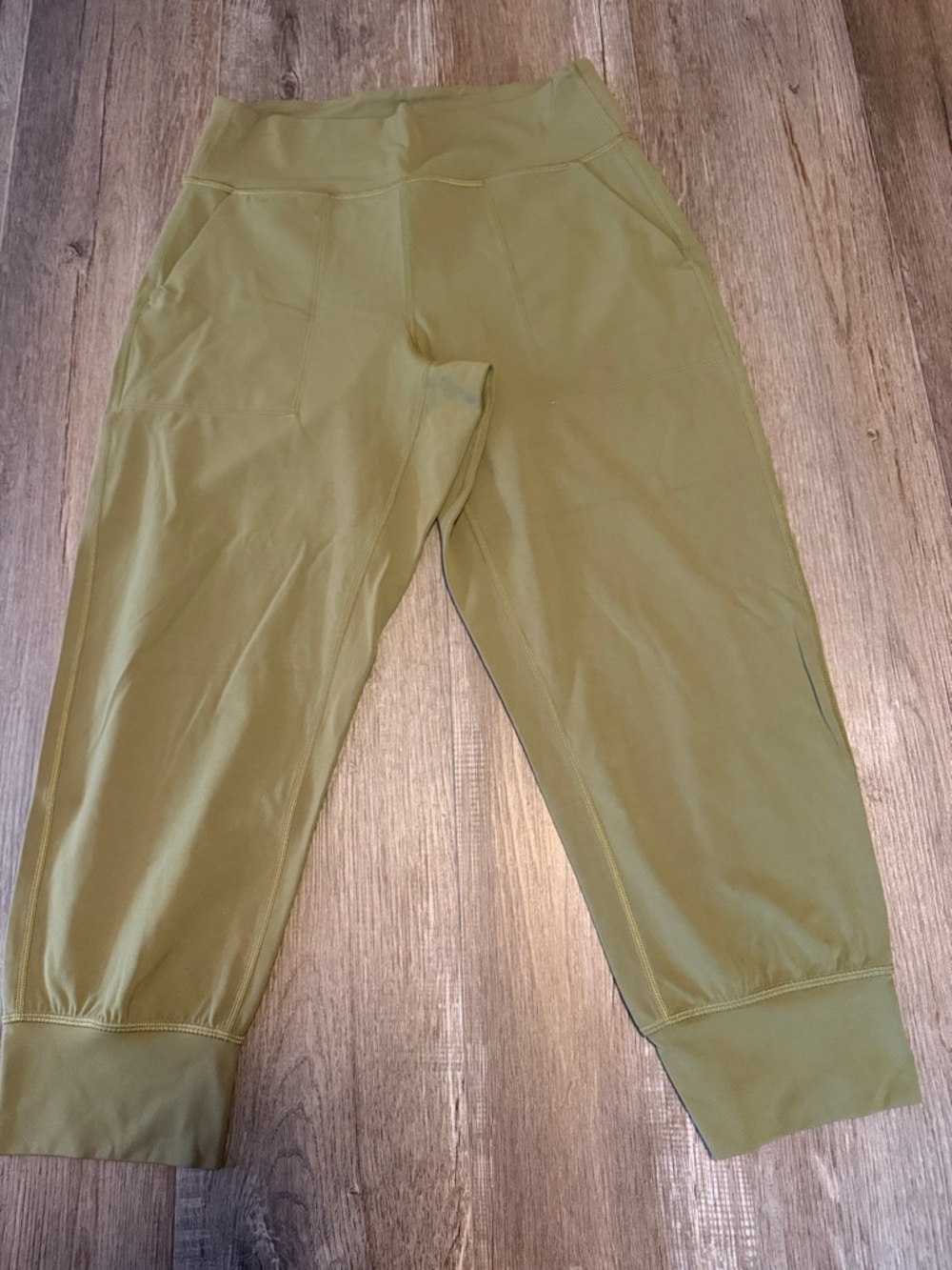 Lululemon Align High-Rise Cropped Jogger Capris in a bronze green color.